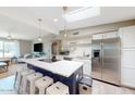 Eat-in kitchen featuring a large island, stainless steel appliances, and seamless flow to the living area at 7802 E Kimsey Ln, Scottsdale, AZ 85257
