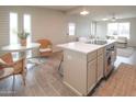 Bright, airy kitchen with stainless steel appliances, an island cooktop, and stylish dining area at 7802 E Kimsey Ln, Scottsdale, AZ 85257