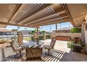 Inviting covered patio featuring a stylish outdoor dining set, perfect for entertaining guests at 10449 W Tropicana Cir, Sun City, AZ 85351