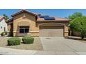 Well-kept one-story home with neutral color palette, tile roof and a paved driveway at 11664 W Eagle Ct, Surprise, AZ 85378