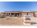 Charming single-story home featuring a two-car garage, solar panels, and low-maintenance landscaping at 1348 W Rockwood Dr, Phoenix, AZ 85027