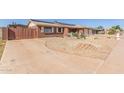 Features an expansive driveway and low-maintenance desert landscaping, adding to its curb appeal at 1348 W Rockwood Dr, Phoenix, AZ 85027