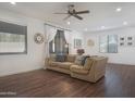 Bright living room featuring a comfortable sectional sofa, wood flooring, and modern decor at 15252 N 100Th St # 1147, Scottsdale, AZ 85260