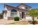 Inviting two-story home with stone accents, arched window, and a well-maintained lawn and landscaping at 16036 N 11Th Ave # 1086, Phoenix, AZ 85023