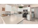 Bright kitchen with white cabinetry, stainless steel appliances, and a tiled backsplash for a clean, modern look at 16036 N 11Th Ave # 1086, Phoenix, AZ 85023