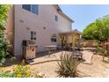 Outdoor patio area with a grill, dining set, and desert plants, perfect for entertaining or relaxation at 16036 N 11Th Ave # 1086, Phoenix, AZ 85023