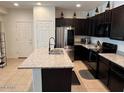 Bright, modern kitchen features a large island, stainless appliances and dark cabinetry at 1718 S 82Nd Way, Mesa, AZ 85209