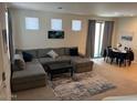 Open living room featuring a plush sectional sofa and modern decor at 1718 S 82Nd Way, Mesa, AZ 85209