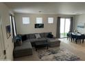 Spacious living room featuring a large sectional sofa, contemporary decor and sliding glass door to backyard at 1718 S 82Nd Way, Mesa, AZ 85209
