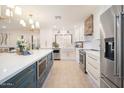 Bright kitchen with stainless steel appliances and a large island perfect for entertaining and food preparation at 18823 N 97Th Ln, Peoria, AZ 85382
