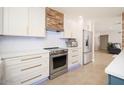 Bright kitchen features white cabinets, stainless steel appliances, and a stylish backsplash, creating a modern culinary space at 18823 N 97Th Ln, Peoria, AZ 85382