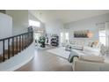 Bright living room with soaring ceilings, a staircase, and modern furniture at 2218 E Anchor Dr, Gilbert, AZ 85234