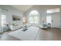 Bright living room with vaulted ceilings, large windows, and comfortable white seating at 2218 E Anchor Dr, Gilbert, AZ 85234