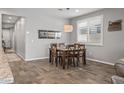 Cozy dining room with a wooden table and neutral color scheme for dining at 22491 E Mewes Rd, Queen Creek, AZ 85142
