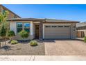 Inviting single-story home featuring desert landscaping and a two-car garage at 22491 E Mewes Rd, Queen Creek, AZ 85142