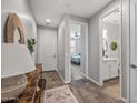 Hallway leading to bedroom and bathroom; features wood-look floors and neutral paint at 22491 E Mewes Rd, Queen Creek, AZ 85142