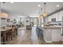Open-concept living room with modern kitchen, dining area, and comfortable seating at 22491 E Mewes Rd, Queen Creek, AZ 85142