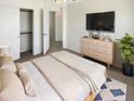 Bedroom featuring closet, ceiling fan, and television at 25038 N 40Th Ave, Phoenix, AZ 85083