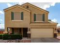 Inviting two-story home featuring a two-car garage, desert landscaping, and a covered front porch at 309 W Settlers Trl, Casa Grande, AZ 85122