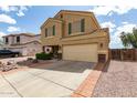 Inviting two-story home featuring a two-car garage, desert landscaping, and a long driveway at 309 W Settlers Trl, Casa Grande, AZ 85122