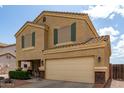 Inviting two-story home featuring a two-car garage, desert landscaping, and a covered front porch at 309 W Settlers Trl, Casa Grande, AZ 85122
