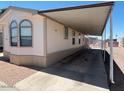 A home with a long carport, ideal for protecting vehicles from the elements at 320 E Mckellips Rd # 152, Mesa, AZ 85201
