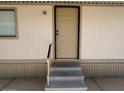 A close-up of the home's entrance, with a small porch, steps and handrails at 320 E Mckellips Rd # 152, Mesa, AZ 85201