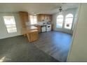 Open kitchen featuring a breakfast bar, white appliances, and wood cabinetry, perfect for cooking and entertaining at 320 E Mckellips Rd # 152, Mesa, AZ 85201