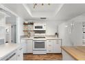 Bright kitchen features white cabinets, marble counters, and appliances in a well-lit space at 4518 W Rose Ln, Glendale, AZ 85301