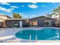 Inviting backyard pool is surrounded by a patio and privacy fencing at 4518 W Rose Ln, Glendale, AZ 85301