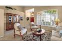 Bright living room with plantation shutters, neutral decor, and an elegant area rug at 4720 E Bighorn Ave, Phoenix, AZ 85044