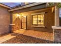 Inviting front porch with stone accents, brick pavers and well maintained desert landscaping at 5443 W Hobby Horse Dr, Phoenix, AZ 85083