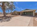 Inviting single-story home with a connected carport and extended driveway, framed by desert landscaping at 7126 N 29Th Dr, Phoenix, AZ 85051