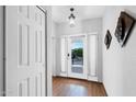 Bright and airy entryway with wood floors, white trim, and a view of the outdoor space at 7750 E Broadway Rd # 538, Mesa, AZ 85208