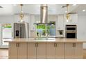 Bright kitchen with modern stainless appliances, island, and view of the backyard at 7823 N Via Del Mundo --, Scottsdale, AZ 85258