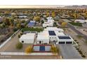 Aerial view of a modern luxury home with a pool, sport court, and desert landscaping at 8520 E Cactus Wren Rd, Scottsdale, AZ 85250