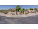 Well-maintained desert landscaping adds charm to the front of the house on a corner lot at 10655 E Broadway Rd, Mesa, AZ 85208