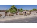 Desert landscaping, featuring gravel and native plants, surrounds the property at 10655 E Broadway Rd, Mesa, AZ 85208