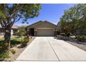 Charming single-story home featuring a well-manicured front yard and a spacious two-car garage at 1141 W Stephanie Ln, San Tan Valley, AZ 85143