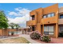 Attractive exterior view showcases balcony, decorative rock, bushes and a community pool at 11640 N 51St Ave # 211, Glendale, AZ 85304