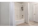 Clean and functional bathroom with a shower-tub combination, white tiles, and modern fixtures at 11841 W Laurel Ln, El Mirage, AZ 85335
