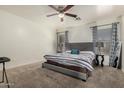 Spacious main bedroom featuring plush carpeting, neutral walls, and stylish curtains for a relaxing retreat at 11841 W Laurel Ln, El Mirage, AZ 85335