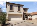 Inviting two-story home with a two-car garage, desert landscaping, and a cozy front porch at 12814 W Edgemont Ave, Avondale, AZ 85392