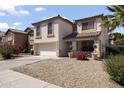 Beautiful two-story home with stucco siding, a two-car garage, and low-maintenance desert landscaping at 12814 W Edgemont Ave, Avondale, AZ 85392