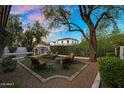 Backyard retreat with a cozy seating area, fire pit, and manicured landscaping, ideal for entertaining at 13131 N 153Rd Ave, Surprise, AZ 85379
