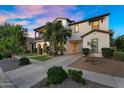 Inviting two-story home showcasing manicured landscaping and a spacious driveway for comfortable living at 13131 N 153Rd Ave, Surprise, AZ 85379
