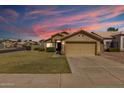 Charming single-story home boasts a well-manicured lawn and neutral-toned exterior with a two-car garage at 1350 E Vaughn Ave, Gilbert, AZ 85234