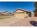 View of a single-story house with a two-car garage and desert landscaping at 1350 E Vaughn Ave, Gilbert, AZ 85234
