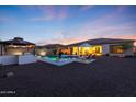 An inviting backyard area featuring a private pool, lounge chairs, outdoor seating, and mature trees at 14979 S 184Th Ave, Goodyear, AZ 85338