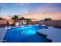 A private backyard pool featuring lush landscaping, a gazebo, and plenty of room for summer fun at 14979 S 184Th Ave, Goodyear, AZ 85338
